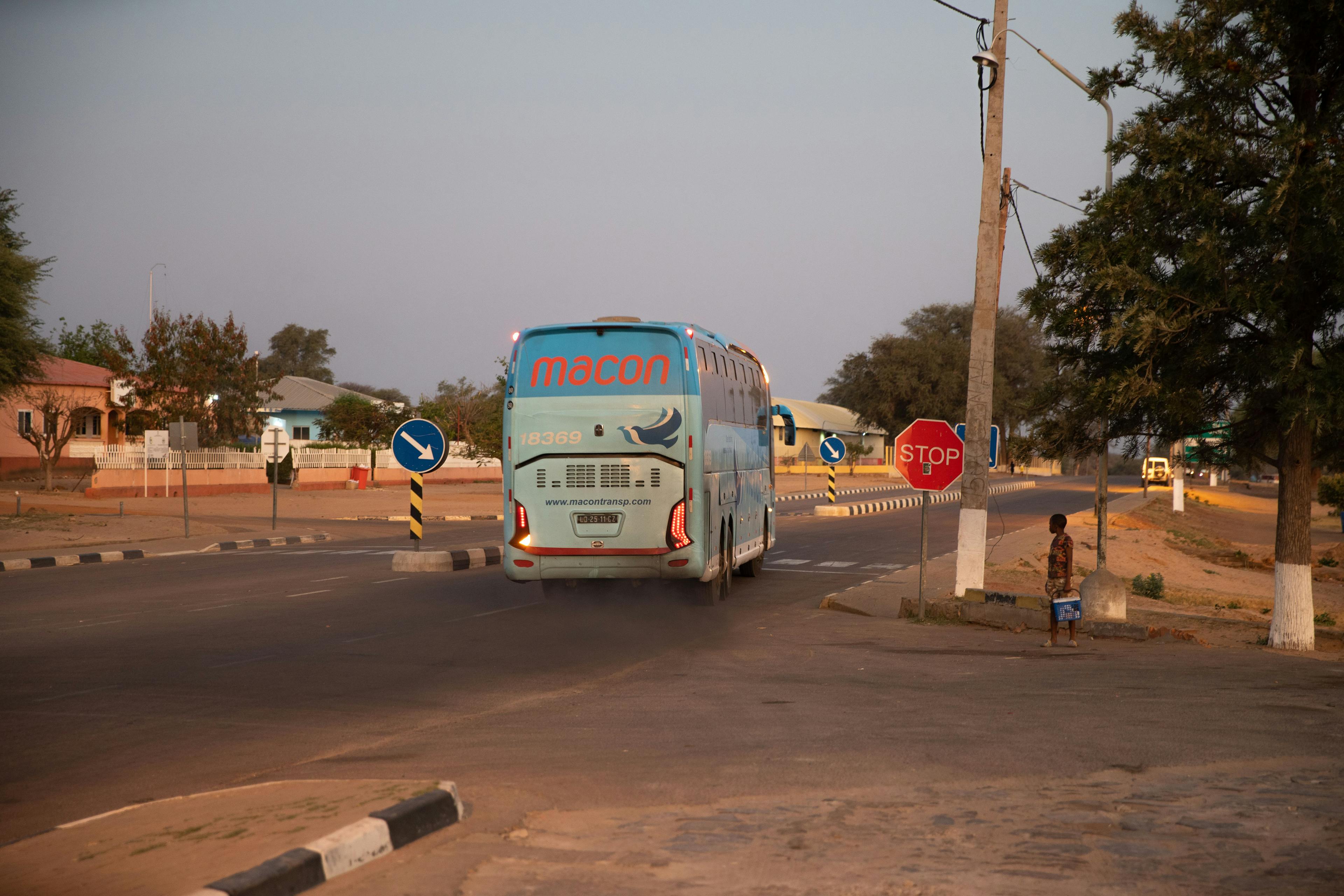 An evening bus pulls away from a gas station. Small cities and towns will be primary destinations for climate mobility. With the right connecting infrastructure and services, stronger rural-urban ties can help local economies flourish. 