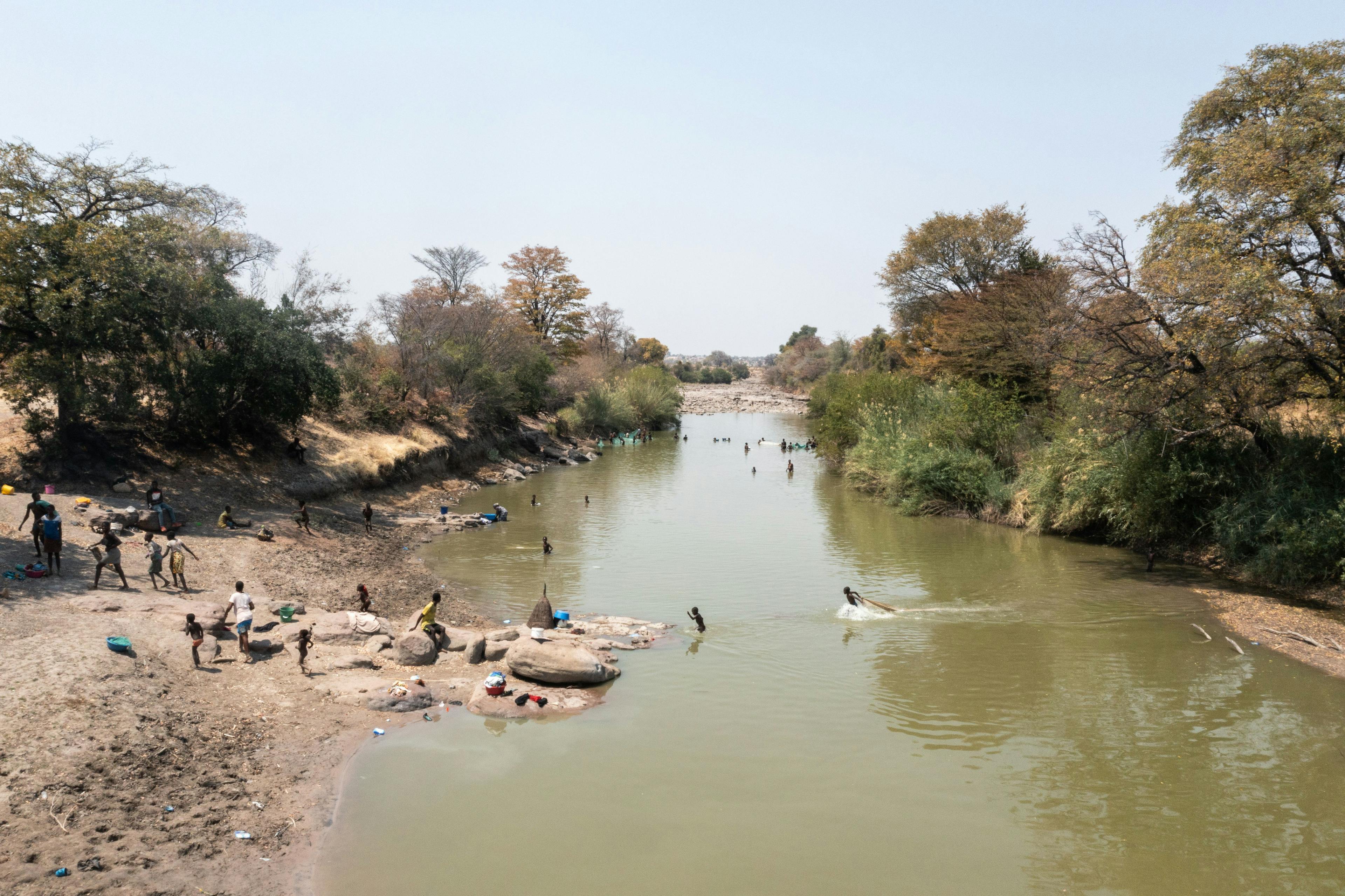 People take to the river to wash their clothing and cool off. Climate change will make some parts of Africa better suited to farming and will draw people to areas where, at least in the near term, water availability improves.  