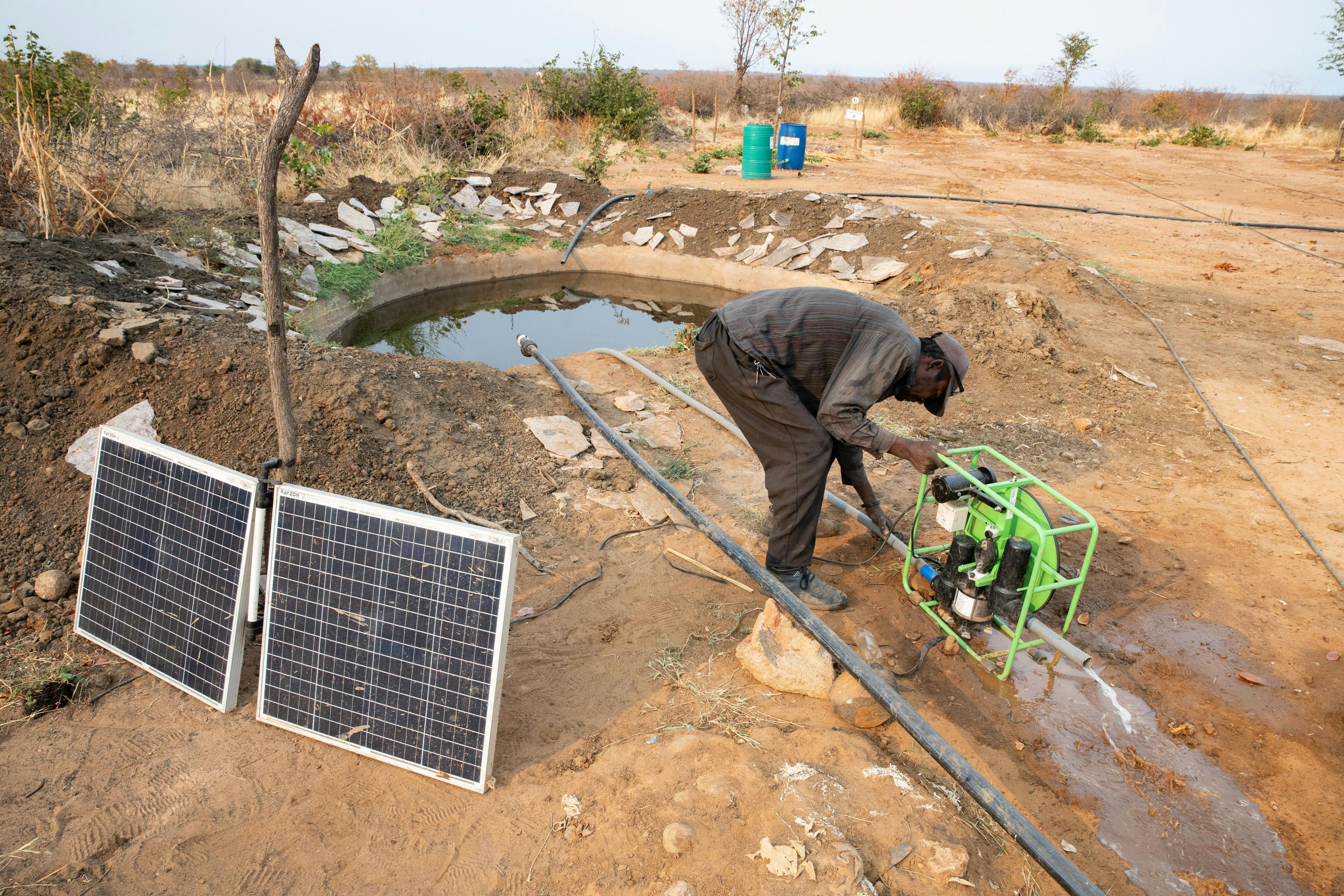 A man starts a solar-powered water pump at a borehole at this training facility. The water is used exclusively to irrigate crops in the nearby fields. Water availability is one of the biggest challenges to ongoing farming success. 